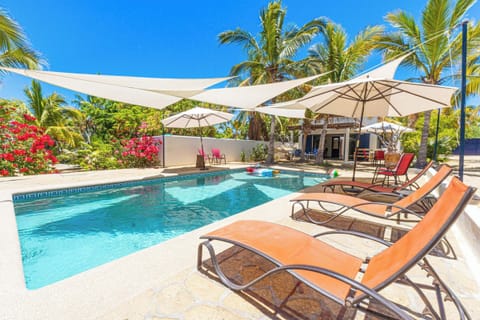 Swimming pool with shades, umbrellas and chairs