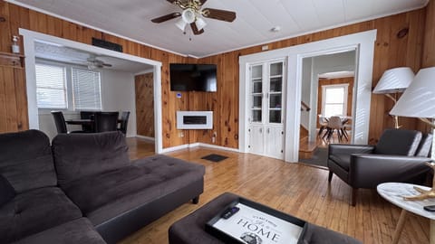 Living room with the game room with poker table to the left.