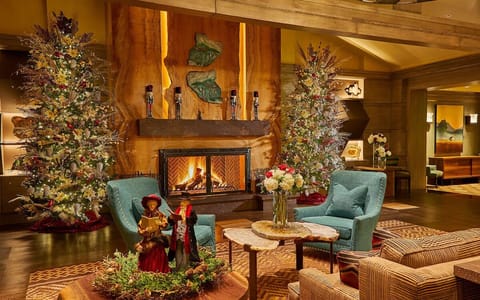 Unwind by the glowing fireplace in a cozy lounge setting.