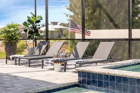 Relax in the sun under the fully enclosed (screened) pool area.