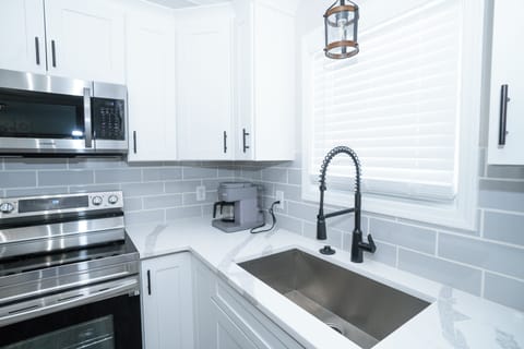 Stylish kitchen with farmhouse sink and subway tile backsplash
