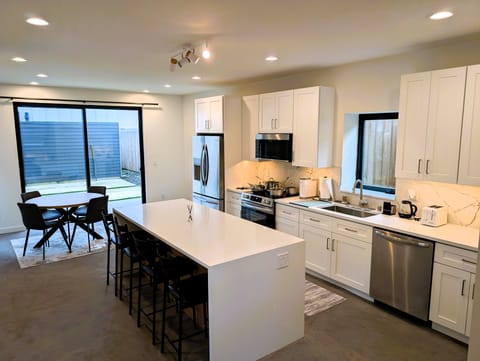 Dining table for 4 and island bar seating for 4 can accommodate 8 guests.