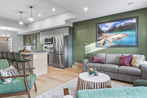 The  living room features cozy seating, a warm fireplace, and a large smart TV for entertainment. With ample natural light and inviting decor, it's the perfect spot to relax, stream your favorite shows, or enjoy quality time with family and friends.