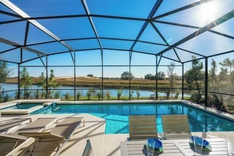 Sunny pool with spa and amazing lake views with sun loungers and dining area