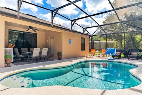 Enjoy your own private screened pool with peaceful nature views, comfortable outdoor seating, and sunny loungers
