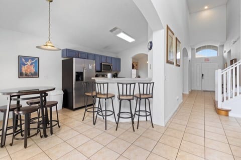 The breakfast bar seating and bar table area is a beautifully designed, resort-style feature that seamlessly integrates functionality .