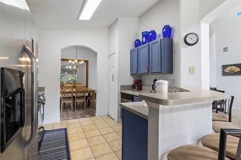 The open-plan kitchen with breakfast bar seating is a stunning, resort-style space that seamlessly blends functionality with elegance.