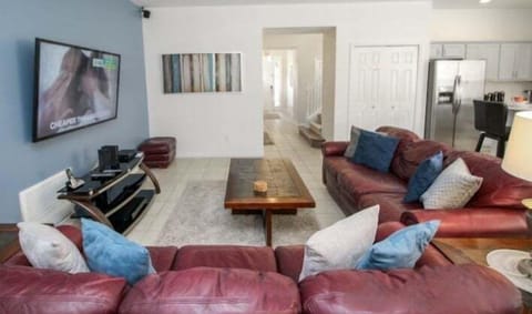 Open-plan living space with views of the sunny pool area.