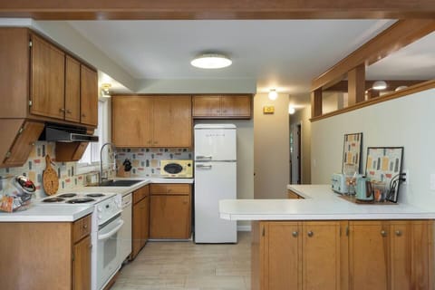 60's inspired kitchen that is stocked with everything you might need to make dinner.