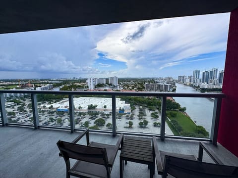Private balcony with outdoor seating and skyline views.