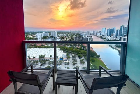 Private balcony with outdoor seating and skyline views.