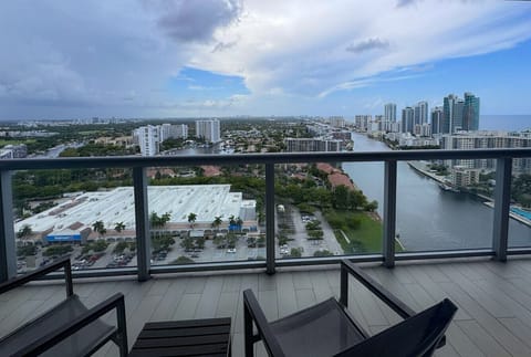 Private balcony with outdoor seating and skyline views.