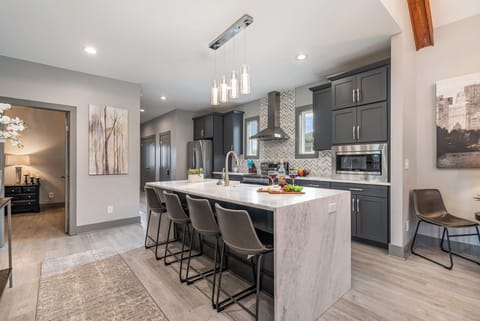 Modern kitchen with sleek countertops, stainless steel appliances, and a spacious island—ready for meals and memories!