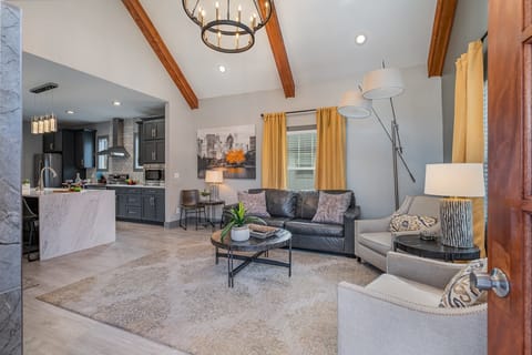Bright and inviting living room with cozy seating, vaulted ceilings, and stylish décor—perfect for relaxing after a day of exploring!