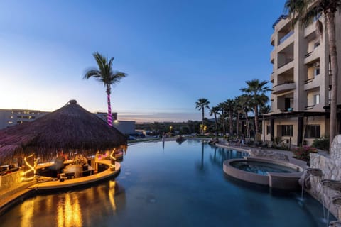 Resort-style pool surrounded by lush gardens