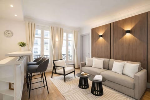 A spacious living area combining a cozy lounge, dining corner, and breathtaking views of the city.