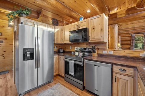The well-stocked kitchen features modern appliances, including a double-door refrigerator, dishwasher, oven, and microwave, ensuring all your culinary needs are met.