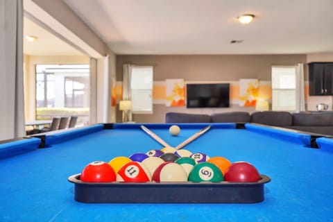Challenge your friends and family to a game of pool in this inviting entertainment space. The sleek billiards table is perfectly positioned, with an open layout that connects seamlessly to the living area and patio for a lively vacation atmosphere.