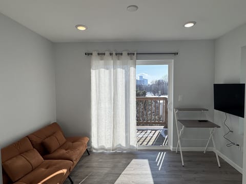 Living room that opens to a private balcony.