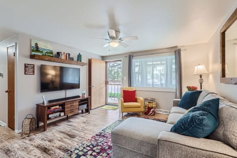 Living room with couch, reading chair, 50” Roku TV with apps