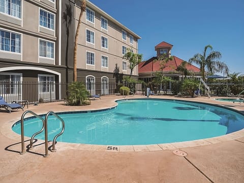Dive into a sparkling outdoor pool under endless blue skies.