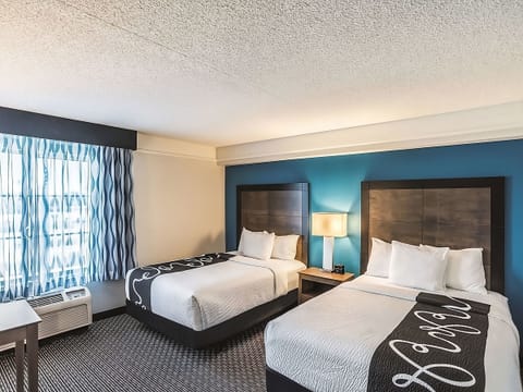Wake refreshed in a bright double-bed room with calm finishes.