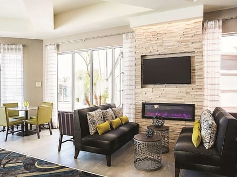 Unwind by the glowing fireplace in a stylish, cozy lounge.