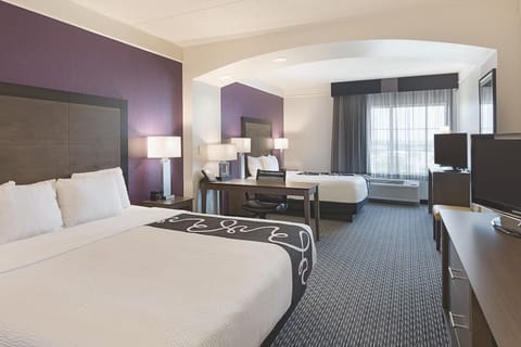 Stretch out in a spacious room with natural light and calm tones.