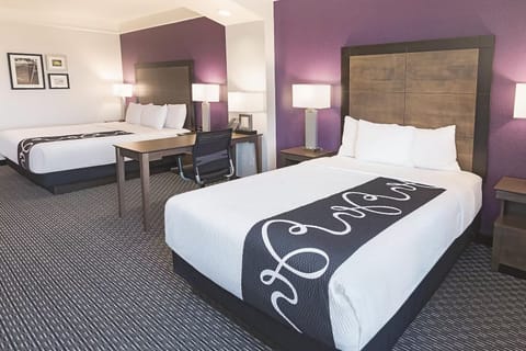 Work and relax easily with a desk between plush beds.