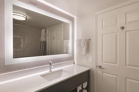 Start your morning at a sleek vanity with bright mirror lighting.