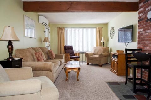 Living Room has a wall mounted Flat Screen TV