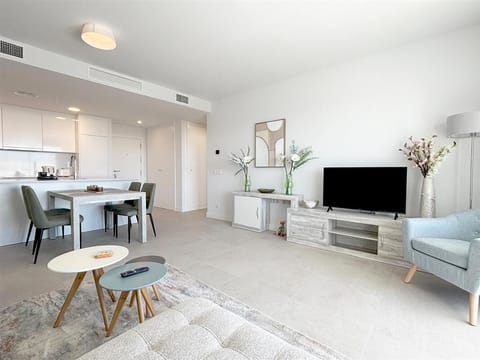 Lounge area with dining area for four guests and open kitchen to the rear