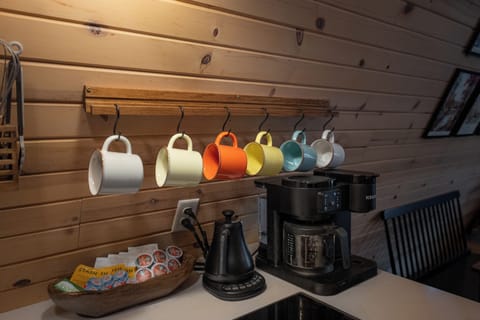 Enjoy a variety of beverage options. The breakfast nook is complete with multicolored mugs, a 2-in-1 Keurig for a pot of coffee or a single k-cup, and a water kettle for hot cocoa or tea.