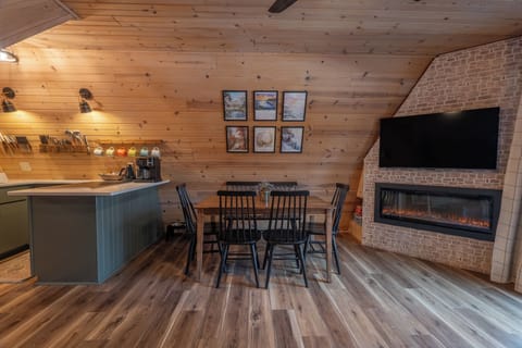 The table for 6 is perfect for meals and games, nestled between the Living room and Kitchen, with a game cubby built into the corner of the fireplace.