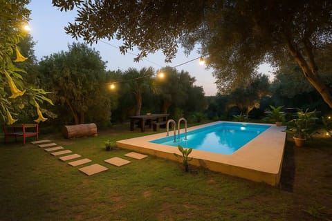 Sunset at the Pool – Enjoy the tranquil glow of evening by the poolside surrounded by olive trees.