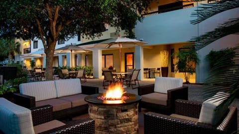 Gather under the stars around a glowing firepit lounge.