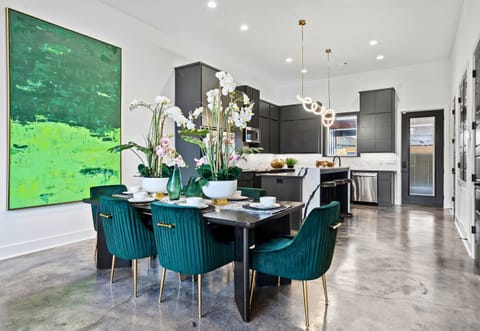 The dining area is both elegant and inviting, with bold pops of color, carefully curated decor, and a stunning view that adds an extra layer of charm.