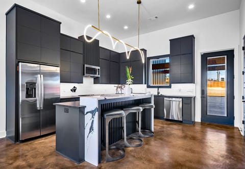 A seamless blend of elegance and functionality, this open-concept kitchen and dining area features sleek finishes, a spacious island, and thoughtful design touches.
