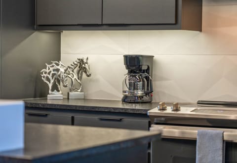 Start your mornings at this elegant coffee station, where sleek modern design and a touch of gold add a bit of luxury to your daily routine.