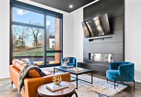 A warm and cozy seating nook, bathed in natural light, combines contemporary design with inviting textures for a relaxing retreat.