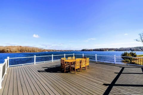 A beautiful two-level dock extends over the lake, complete with a dining area and stunning water views, ideal for relaxation and entertaining.