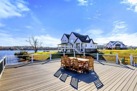 A beautiful two-level dock extends over the lake, complete with a dining area and stunning water views, ideal for relaxation and entertaining.