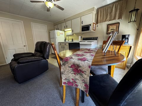 Recliner and dining table for four.