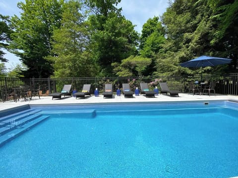In ground, heated pool with electric cover is located just off the patio.