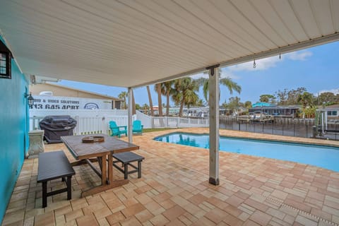Back patio and pool with canal view