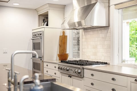 The kitchen is equipped with a stovetop and a double oven