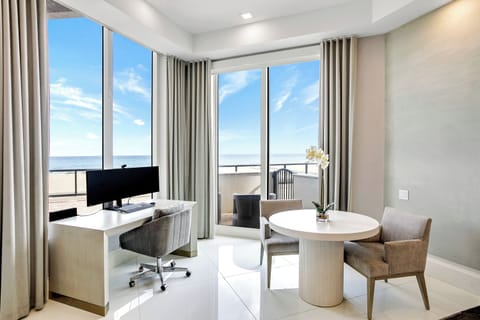 Large windows with sliding door, 12' ceilings with unobstructed ocean views.