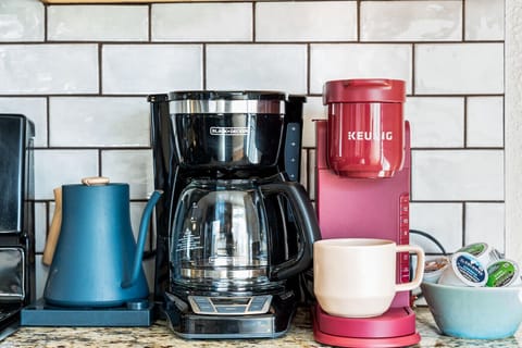 A coffee bar complete with Keurig, drip coffee, and tea kettle