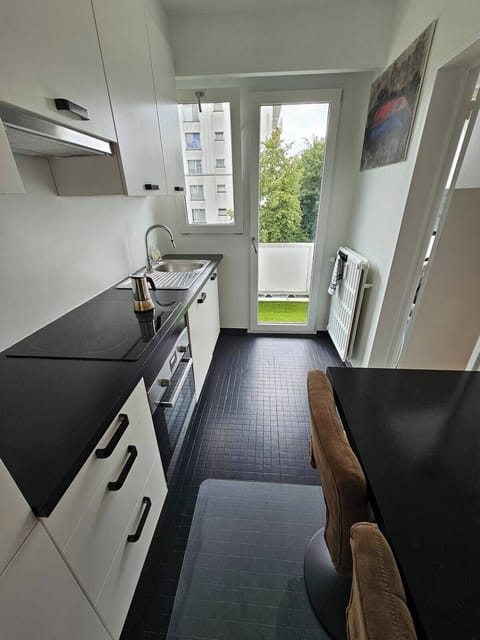 Kitchen with breakfast bar and two barstools that leads into terrace.