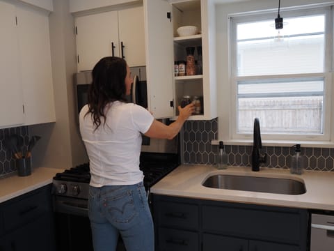 Kitchen is stocked with spices and coffee essentials.